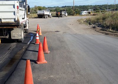Repairing Damaged Asphalt On Roadway To City Of Saskatoon Landfill